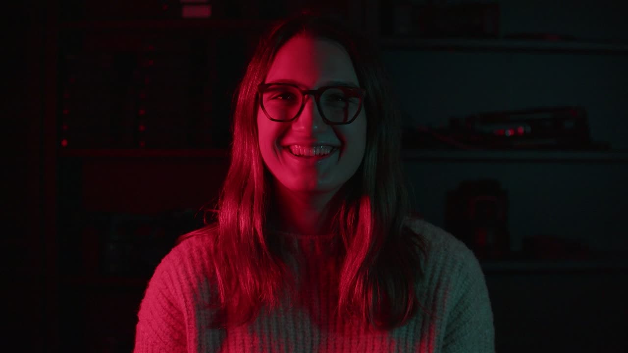 Portrait split between teal and red light