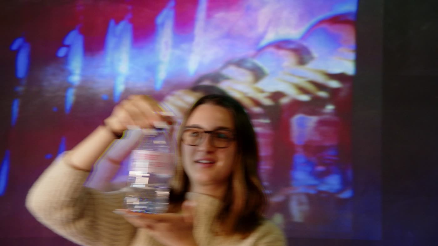 Raising the bottle, the projection breaks into streaks